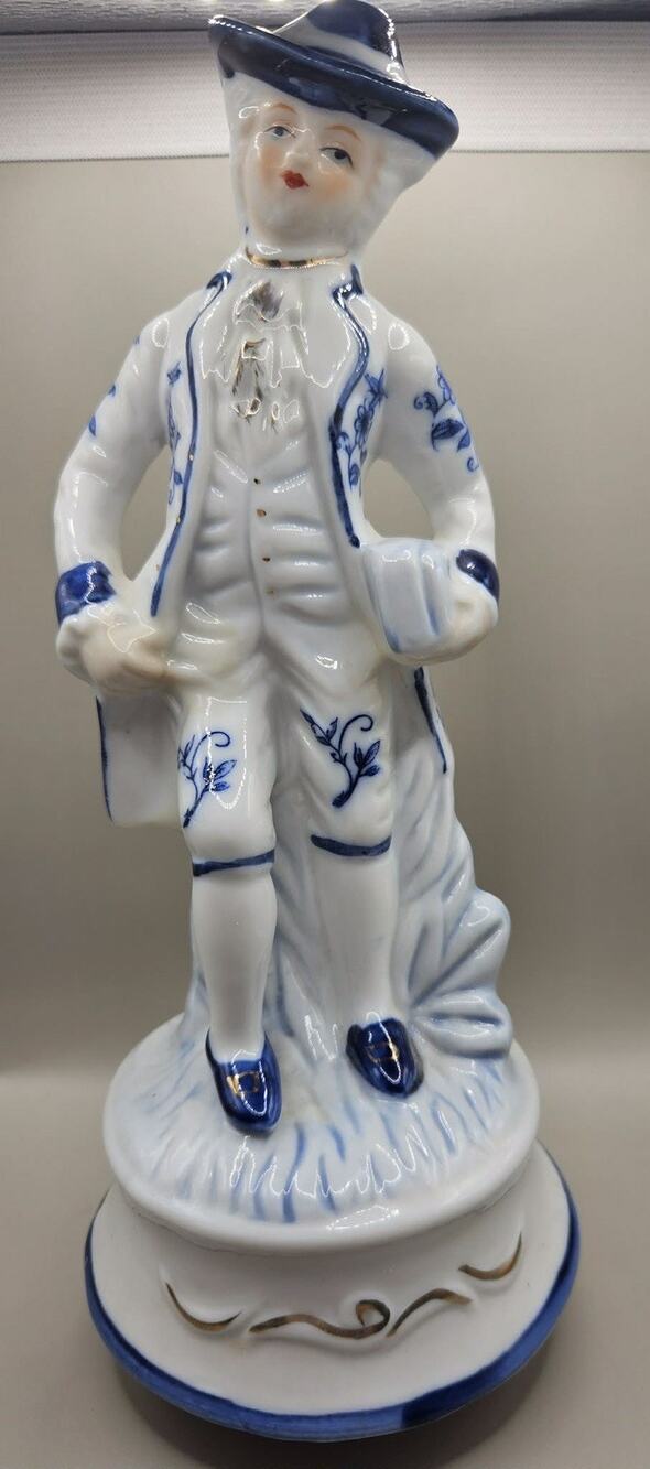 Vintage blue and white Victorian man porcelain figurine music box with gold trim